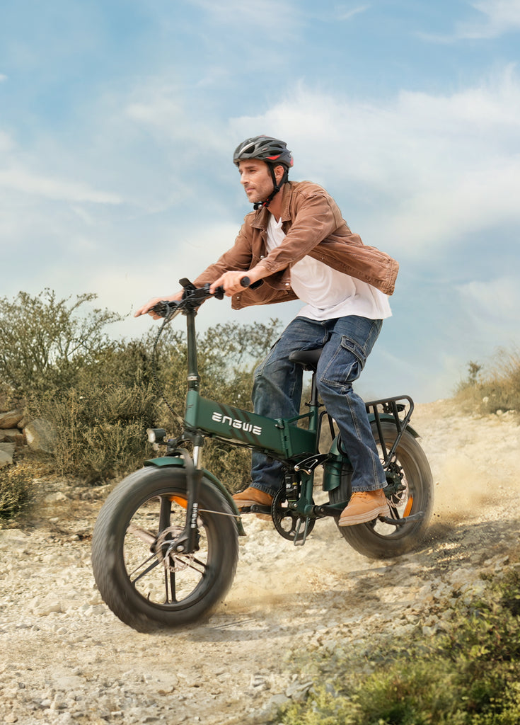 a man wearing an engwe helmet rides an engwe engone pro 2.0 e-bike on the gravel road