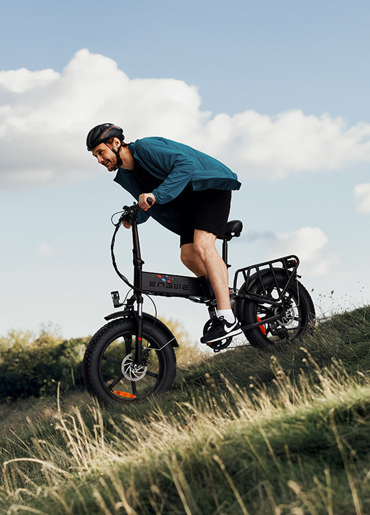 a man rides an engwe engine x e-bike on the grass