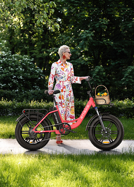 a woman standing next to the flamingo pink engwe l20