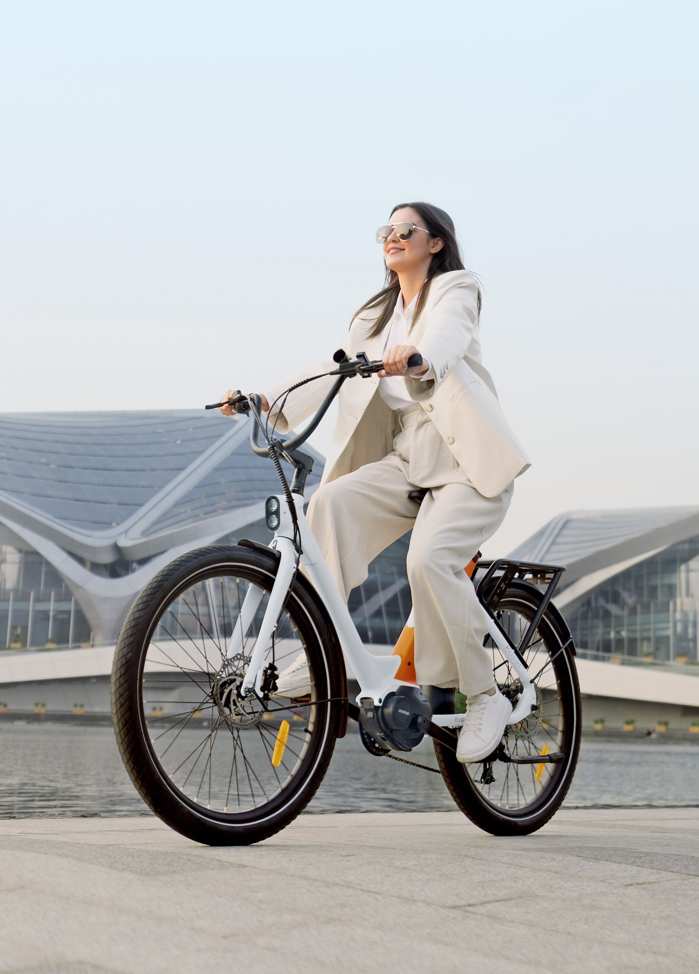 a woman riding an engwe p275 st city e-bike on a city road